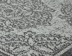 Abstract area rug featuring a mix of intricate patterns and textures.