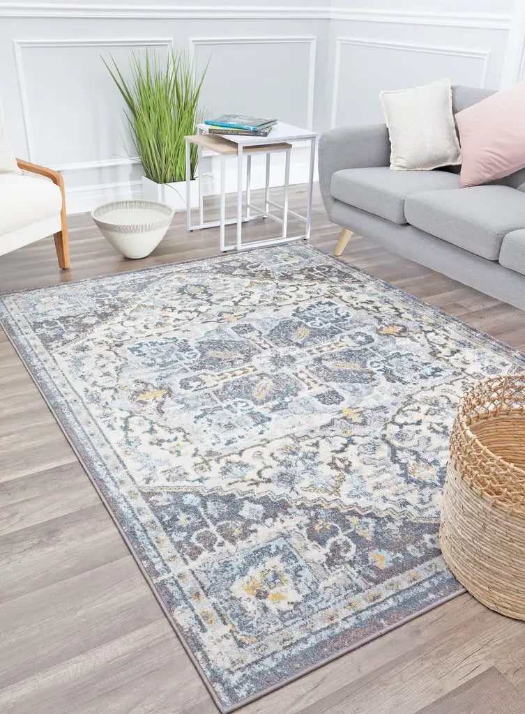 Traditional area rug with a distressed blue and beige floral pattern, perfect for adding a vintage touch to any room.