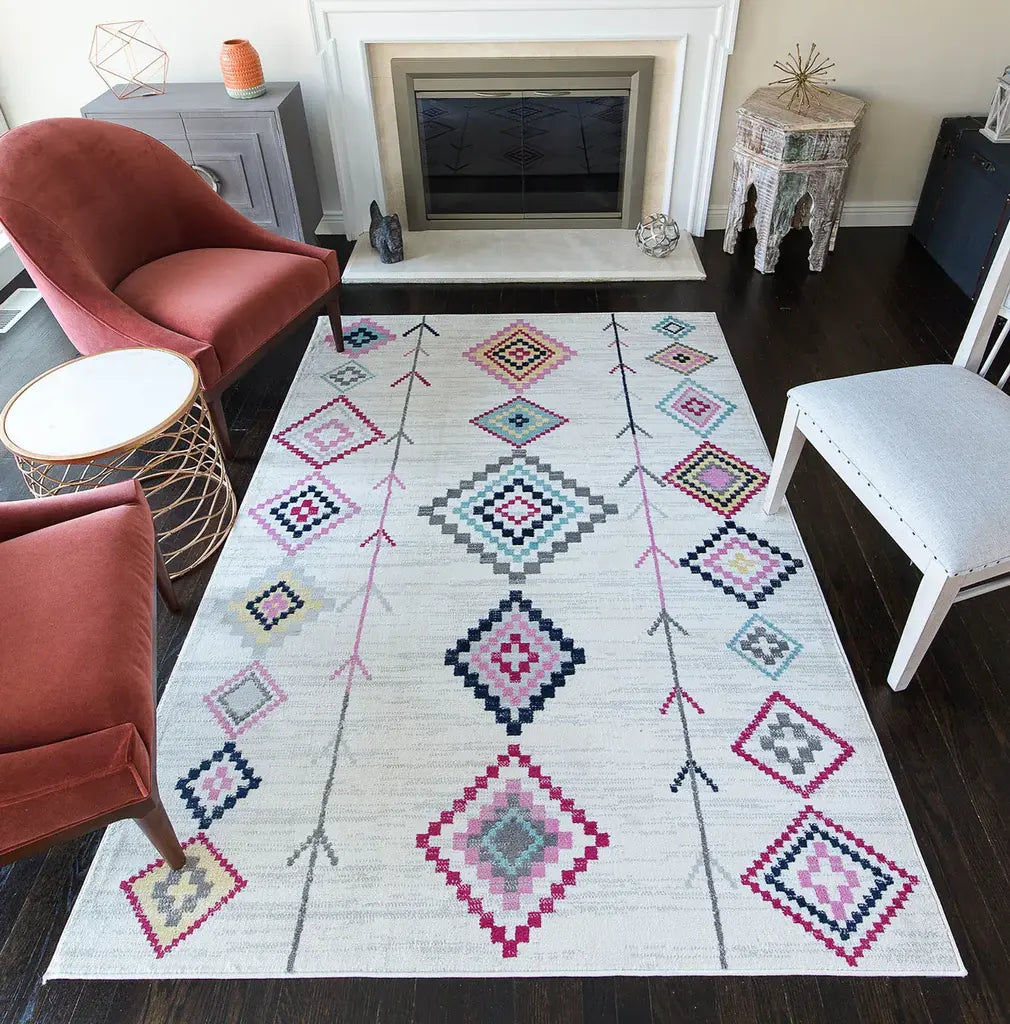 White rug with colorful geometric diamond patterns in a living room with a red chair, fireplace, and modern decor.