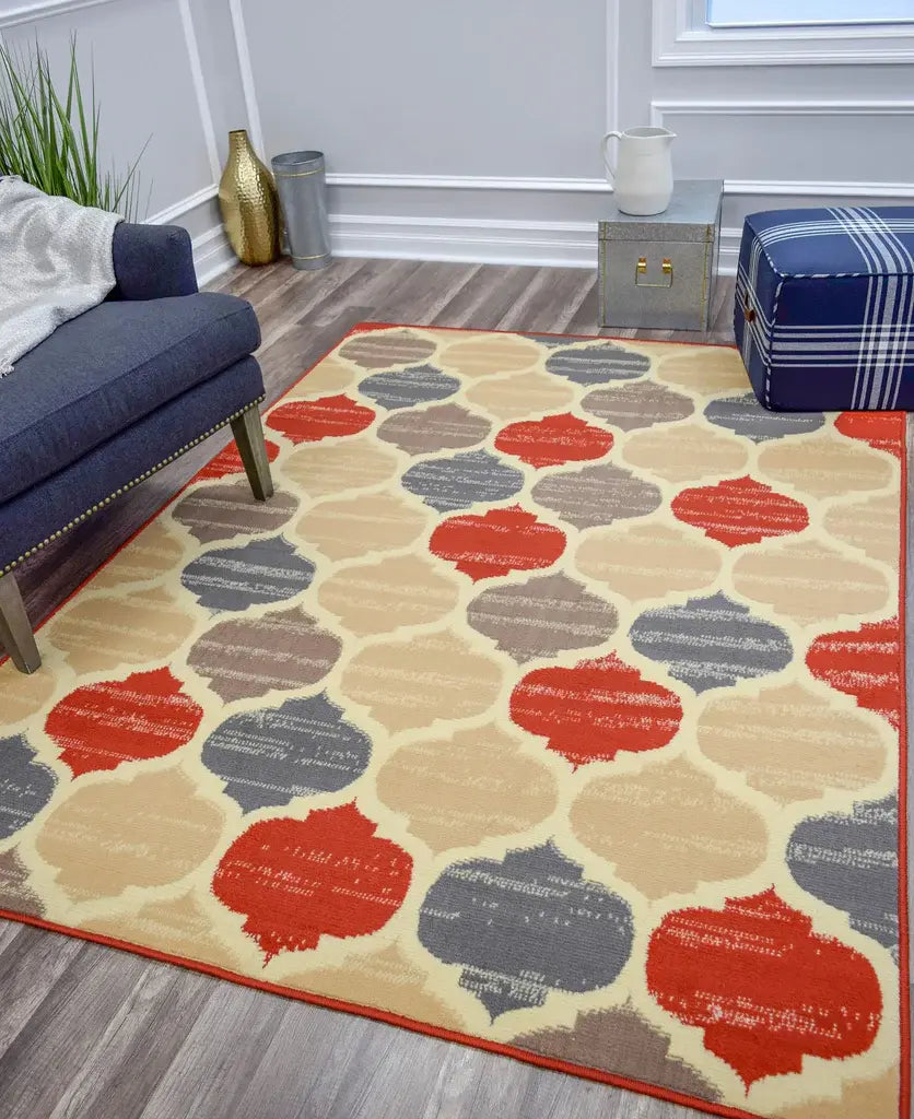 Vibrant living room with a colorful geometric patterned rug, navy blue sofa, plaid ottoman, and modern decor elements for a lively ambiance