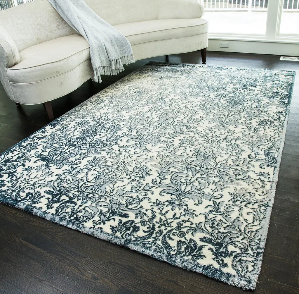 Elegant area rug with intricate blue and white floral patterns, perfect for enhancing a living room's decor.