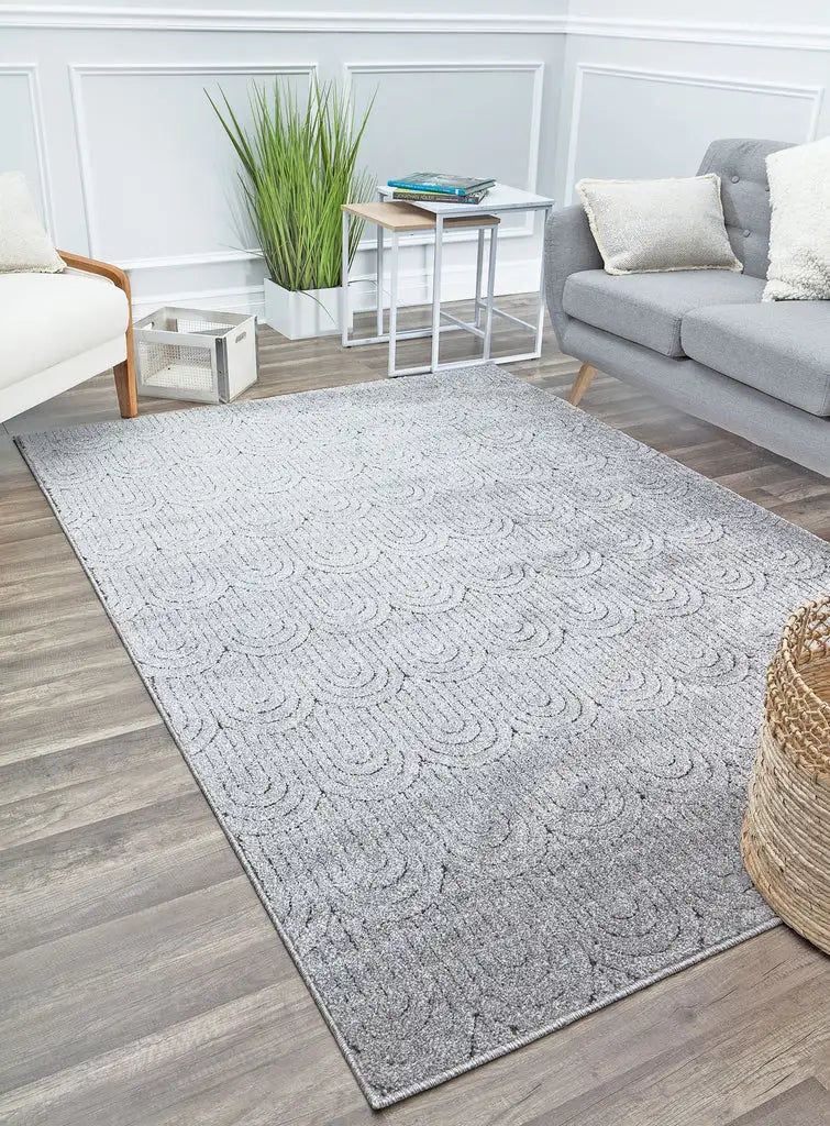 Modern light gray area rug with subtle textured patterns, perfect for adding a minimalist and elegant touch to any living room.