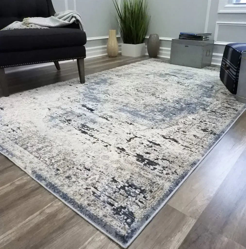 Modern distressed area rug in neutral tones, perfect for adding a contemporary and stylish touch to any living room.