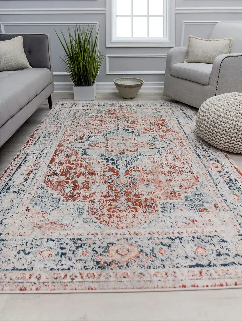 Vintage-style rug with an intricate blue and beige floral pattern, featuring a central medallion and decorative border design