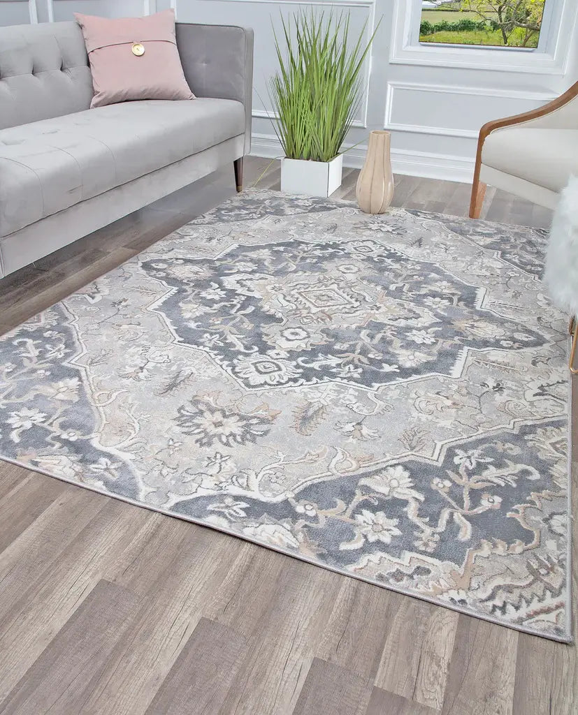 Elegant living room with a gray and white floral patterned rug, a gray sofa with pink cushions, and modern decor elements