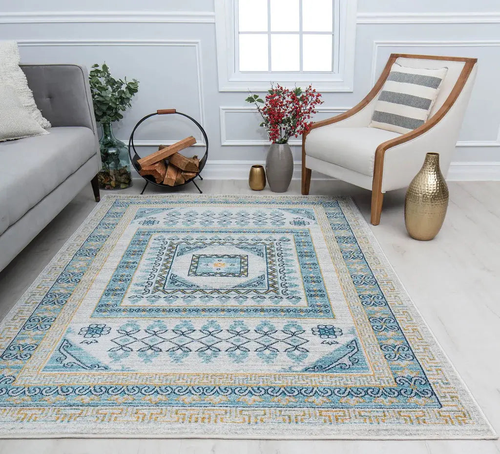 Charming living room with a blue and yellow patterned rug, gray sofa, wooden armchair, and stylish decor elements for a cozy feel