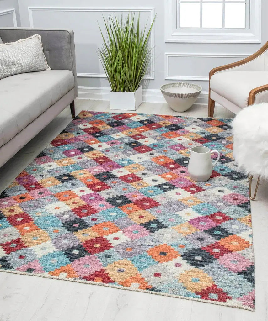 Colorful geometric rug with a vibrant mix of patterns, styled in a cozy living room with modern furniture and decor.