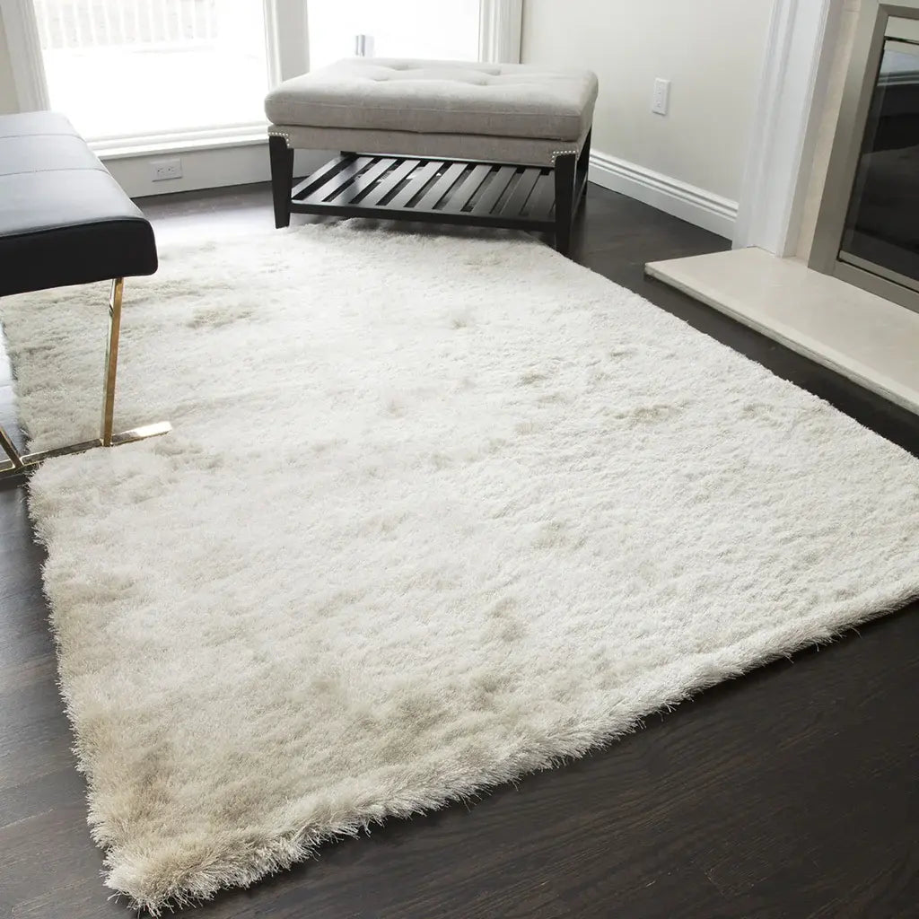 Luxurious white shag rug in a modern living room setting, complemented by dark hardwood floors and minimalist furniture