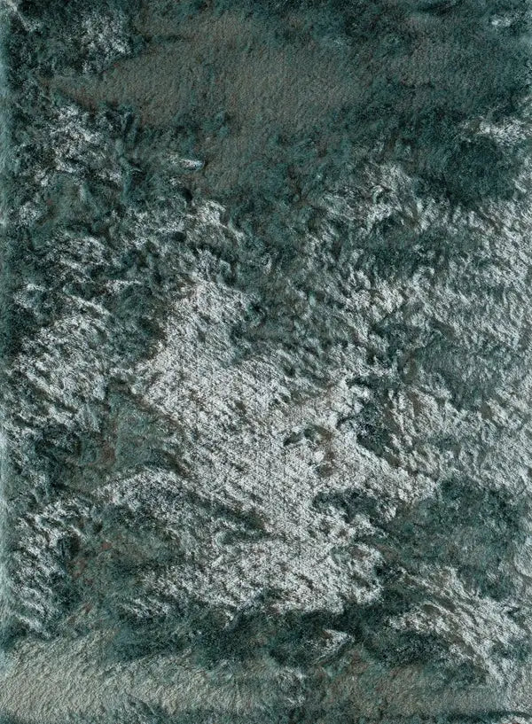 Close-up of a textured Luster Shag rug with a mix of grey and white fibers, showcasing its intricate, soft, and plush design.