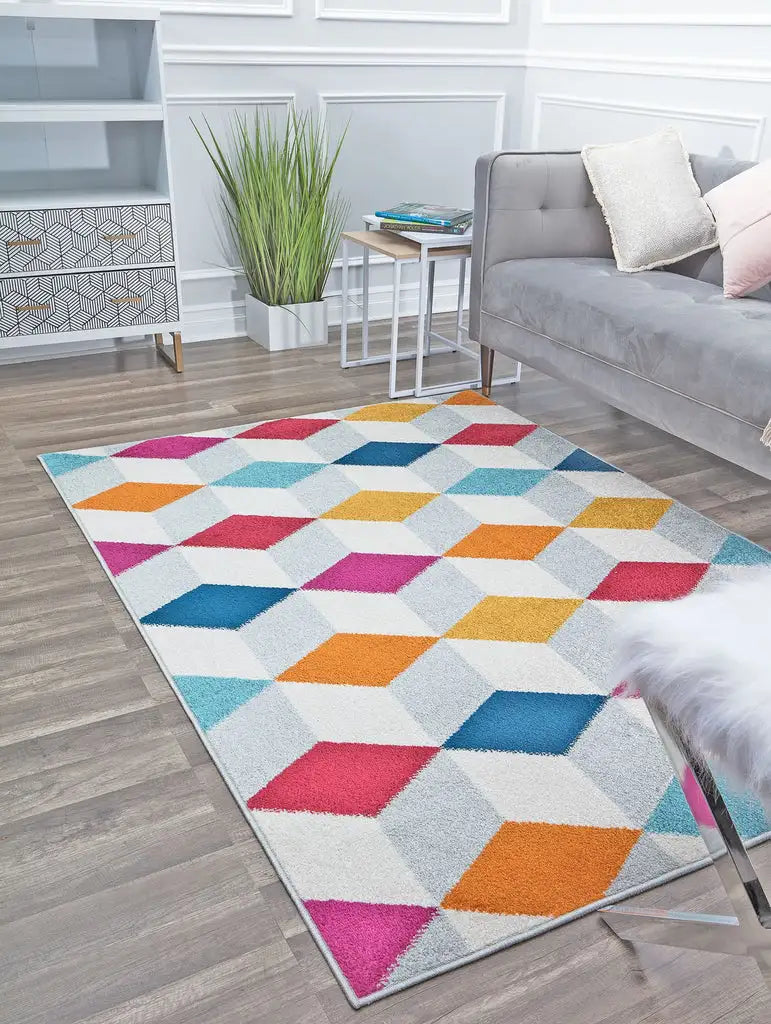 Vibrant living room with a colorful geometric patterned rug, gray sofa, modern furniture, and green plant decor, adding a playful touch