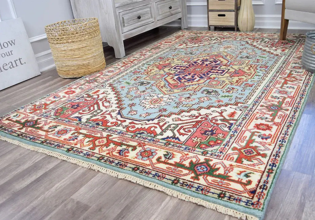 Colorful living room with a traditional Persian rug, rustic furniture, a wicker basket, and a decorative sign for cozy ambiance.