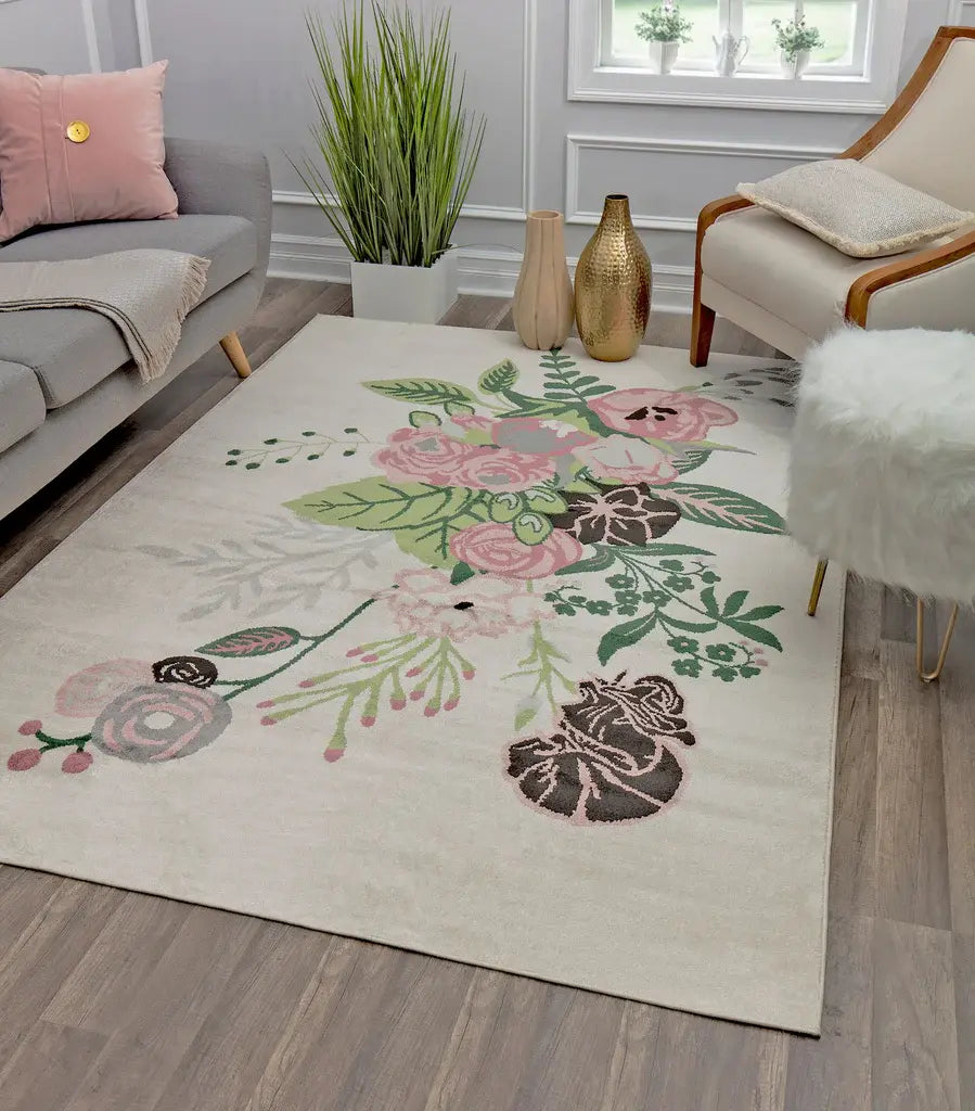 Floral-patterned rug in a stylish living room with a grey sofa, pink pillows, a potted plant, and decorative golden vases